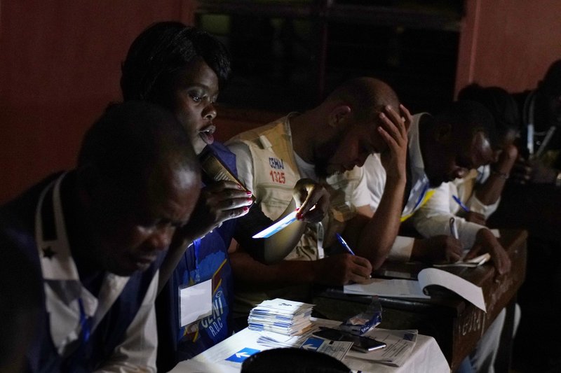 Electoral commission officials tally the presidential ballots in Kinshasa,  on Sunday Dec. 30, 2018. (AP Photo/Jerome Delay)