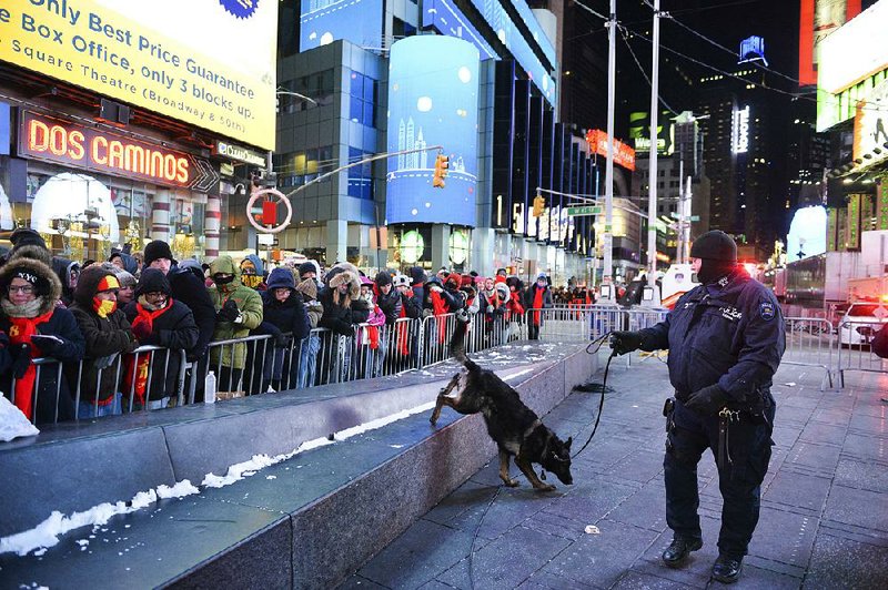 In this file photo, a police K-9 unit patrols in New York’s Times Square where crowds were gathered for the annual New Year’s Eve celebration.