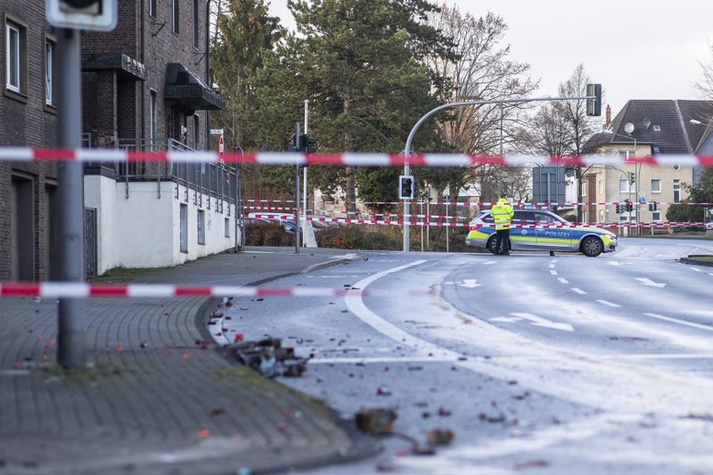 The Police blocks a road in Bottrop, Germany, Tuesday, Jan. 1, 2019. A man has been arrested in Germany after ploughing his car into a crowd of people, injuring at least four, in what appears to have been an intentional attack directed at foreigners, police said Tuesday. (Marcel Kusch/dpa via AP)

