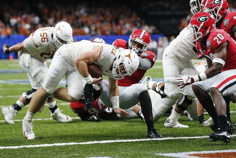 Texas quarterback Sam Ehlinger crosses the goal line as Georgia linebacker Natrez Patrick defends during the first half of the Sugar Bowl in New Orleans. The No. 15 Longhorns beat the No. 5 Bulldogs 28-21.