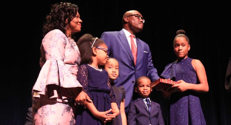 New Little Rock Mayor Frank Scott Jr. is joined by his mother, Brenda Scott (left), and cousins (from left) Jillian Phillips, 8, Kaylee Scott, 6, Jonathan Phillips II, 4, and Katelyn Scott, 10, as he takes the oath of office Tuesday as administered by Judge Alice Gray.