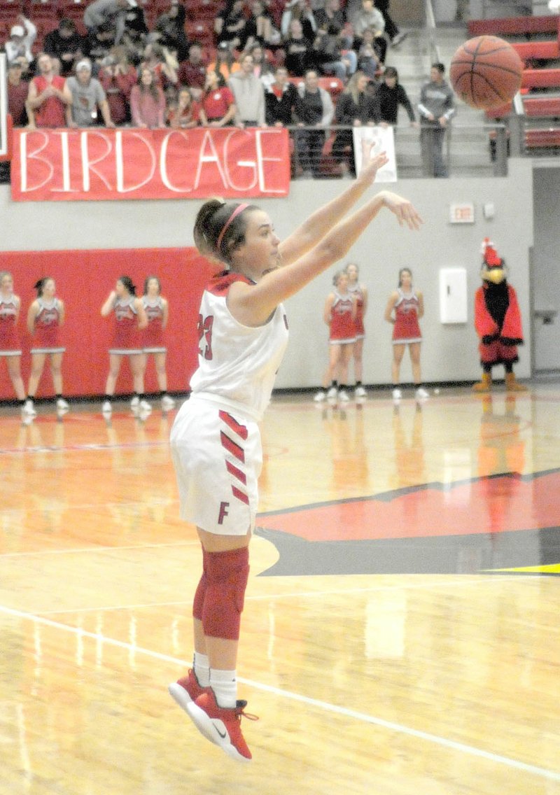 MARK HUMPHREY ENTERPRISE-LEADER Farmington sophomore Trinity Johnson, shown making a 3-pointer at home against Prairie Grove Friday, Dec. 14, adds another dimension to the Lady Cardinals' perimeter game with her consistent outside shooting. She is the daughter of Farmington head coach Brad Johnson and scored 9 points in a 55-52 loss at Greenwood on Tuesday, Dec. 11, 2018.