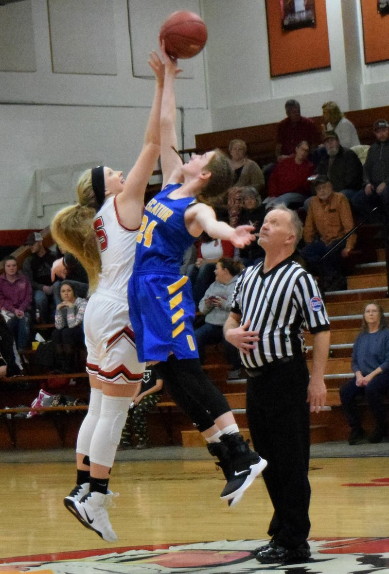 Westside Eagle Observer/MIKE ECKELS Sammie Skaggs (Decatur 24) gains control of the opening tip-off during the Decatur-Exeter girls' basketball contest in the main gym at Exeter High School in Missouri Dec. 20. The Lady Tigers handed the Lady Bulldogs yet another lost, 46-35, to end the 2018 portion of the basketball season.