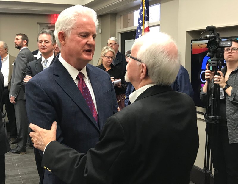 Outgoing highway commissioner Dick Trammel (right) talks with incoming commissioner Keith Gibson Wednesday after Gibson was announced to the position. 