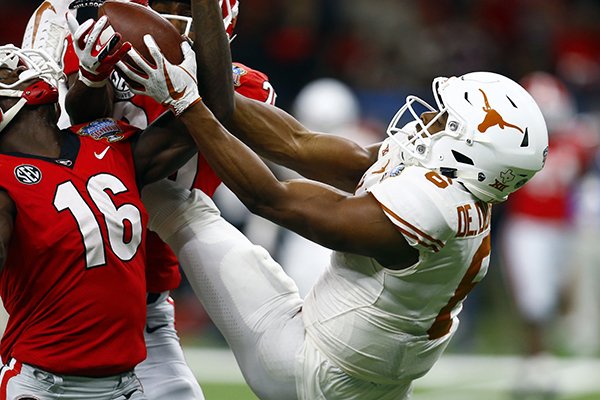 Texas wide receiver Devin Duvernay (6) tries to pull in a pass that was intercepted, but overturned by replay, in the second half of the Sugar Bowl NCAA college football game against Georgia in New Orleans, Tuesday, Jan. 1, 2019. (AP Photo/Butch Dill)