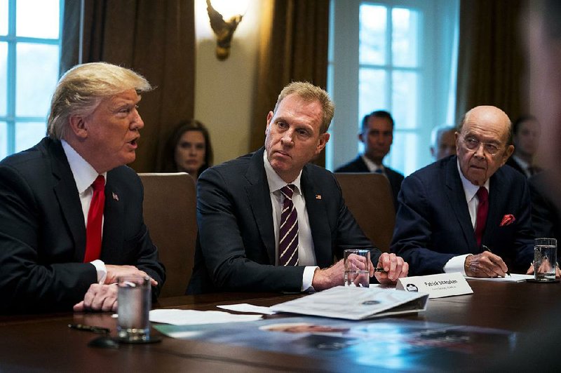 Acting Defense Secretary Patrick Shanahan (center) looks on as President Donald Trump speaks with members of his Cabinet in the Cabinet Room of the White House in Washington, Jan. 2, 2019. Commerce Secretary Wilbur Ross is shown at right. 