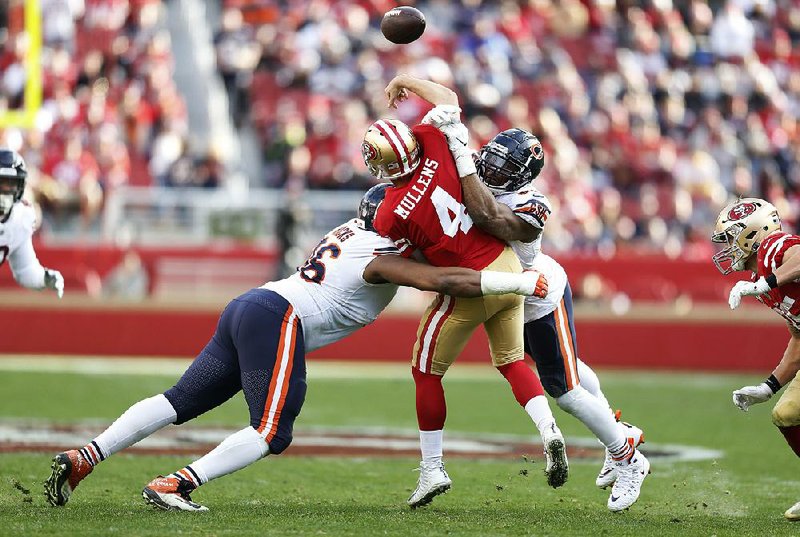 Chicago Bear defenders Khalil Mack (right) and Akiem Hicks (left) hit San Francisco 49ers quarterback Nick Mullens earlier this season. After one of the NFL’s most prolific offensive regular seasons ever, it remains to be seen if top defenses can still lead the way to a championship.
