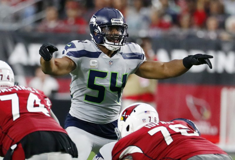 In this Sept. 30, 2018, file photo, Seattle Seahawks linebacker Bobby Wagner (54) gestures at the line of scrimmage during an NFL football game against the Arizona Cardinals in Glendale, Ariz.  (AP Photo/Rick Scuteri, File)