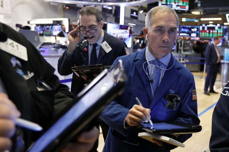 Timothy Nick, right, works with fellow traders on the floor of the New York Stock Exchange, Thursday, Jan. 3, 2019. Apple's shock warning that its Chinese sales are weakening ratcheted up concerns about the world's second largest economy and weighed heavily on global stock markets as well as the dollar on Thursday. (AP Photo/Richard Drew)

