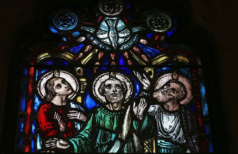 John, Peter and Paul gaze toward heaven in a depiction of the Christian church’s beginning as it was described in the Book of Acts, in a stained glass window at Little Rock’s Christ Episcopal Church. The window is one of 30 that was removed from the church and restored in Germany in a three-year, $1 million restoration project more than 70 years after the windows were originally installed in the church building. 