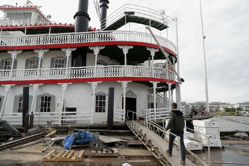 Matt Dow, project manager for the restoration of the City of New Orleans riverboat, walks onto the vessel in New Orleans. 