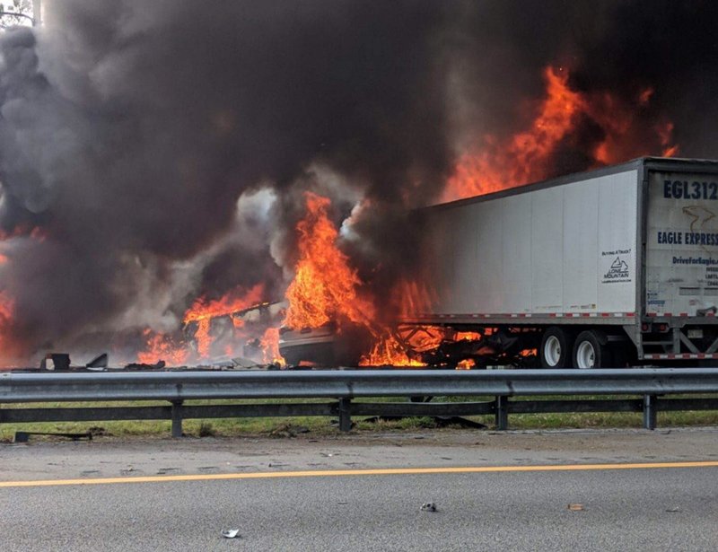 Flames engulf vehicles after a fiery crash along Interstate 75, Thursday, Jan. 3, 2019, about a mile south of Alachua, near Gainesville, Fla. Highway officials say at least six people have died after a crash and diesel fuel spill sparked a massive fire along the Florida interstate. (WGFL-Gainesville via AP)

