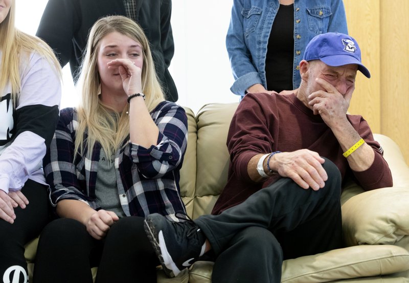 In this Thursday, Jan. 3, 2019 photo, T. Scott Marr and his daughter, Preston Marr, left, break down during a press conference in Omaha, Neb. Thought to be brain dead, T. Scott Marr awakened after being taken off life support. (Kent Sievers/Omaha World-Herald via AP)

