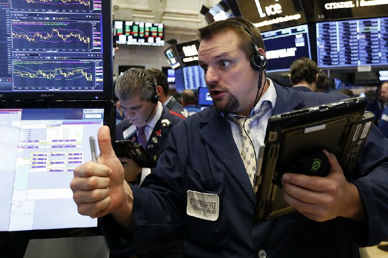 Trader Michael Milano works Friday on the floor of the New York Stock Exchange, where the Dow gained 747 points after losing 660 on Thursday. 