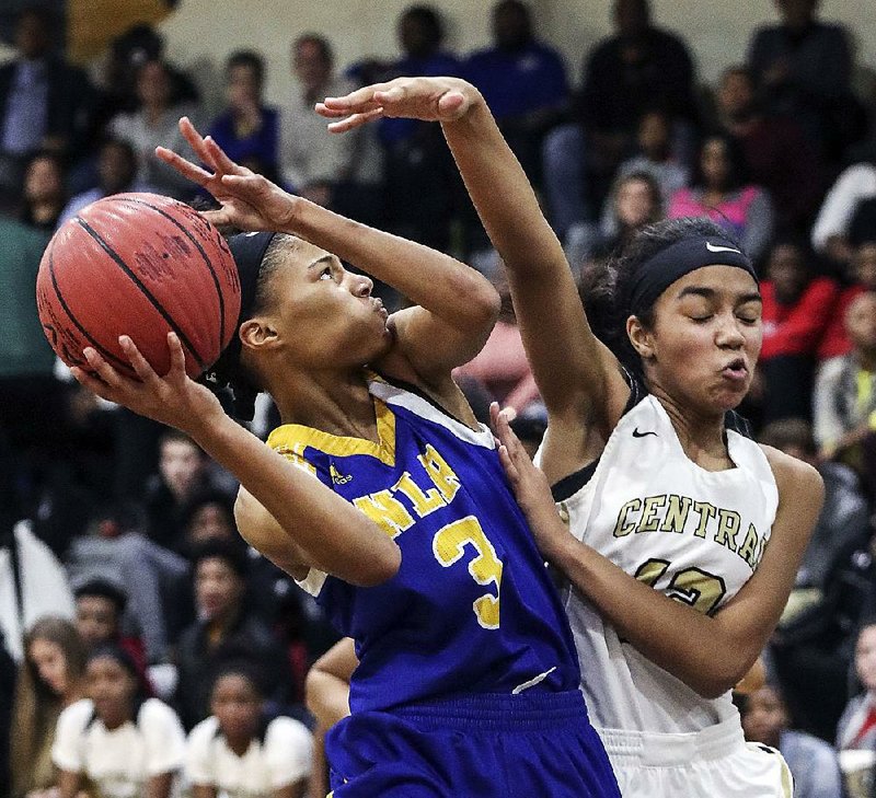 North Little Rock’s Arin Freeman (3) looks for a shot as Little Rock Central’s Lillian Jackson defends Friday in Little Rock. For more photos, go to www.arkansasonline. com/galleries.