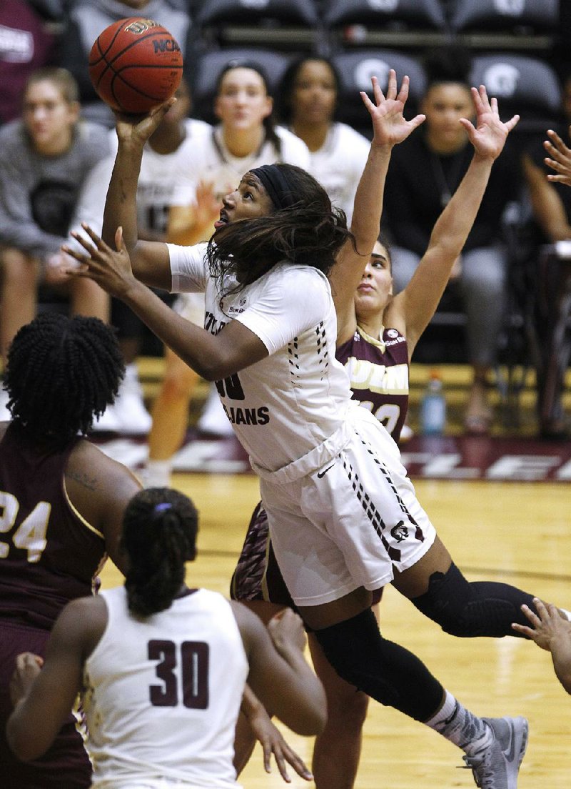 UALR’s Ronjanae DeGray puts up a shot during the fourth quarter of the Trojans’ 63-44 victory Thursday against Louisiana-Monroe at the Jack Stephens Center in Little Rock. DeGray had 23 points in UALR’s first victory on its home floor since Nov. 14.