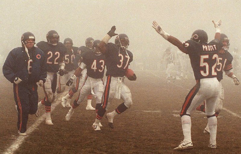 Chicago Bears defensive back Maurice Douglass (37) celebrates with teammates after making an interception late in the Bears’ victory over the Philadelphia Eagles in a 1988 divisional playoff game, known as the Fog Bowl. The teams meet again in a wild- card playoff game Sunday.