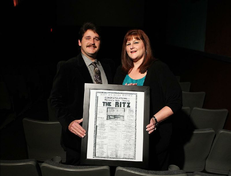 Marty Nix and Marla Nix pose inside Malvern’s Ritz Theatre in 2013 with an ad that was published in 1938. 