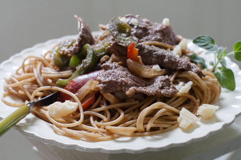 This June 9, 2014 file photo shows a dish of steak and cheese pasta in Concord, N.H. Two major studies in 2018 provided more fuel for the debate around carbs and fats, yet failed to offer a resolution to the polarizing matter of the best way to lose weight. (AP Photo/Matthew Mead)

