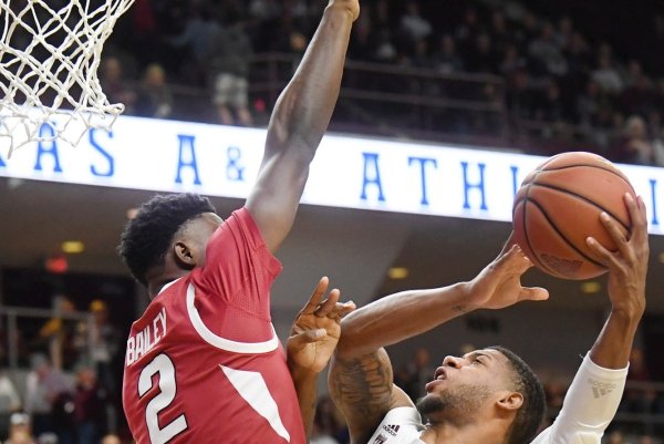 Arkansas' Adrio Bailey (2) defends at the basket as Texas A&M's Savion Flagg (1) attempts to shoot in the first half of an NCAA college basketball game Saturday, Jan. 5, 2019, in College Station, Texas. (Laura McKenzie/College Station Eagle via AP)