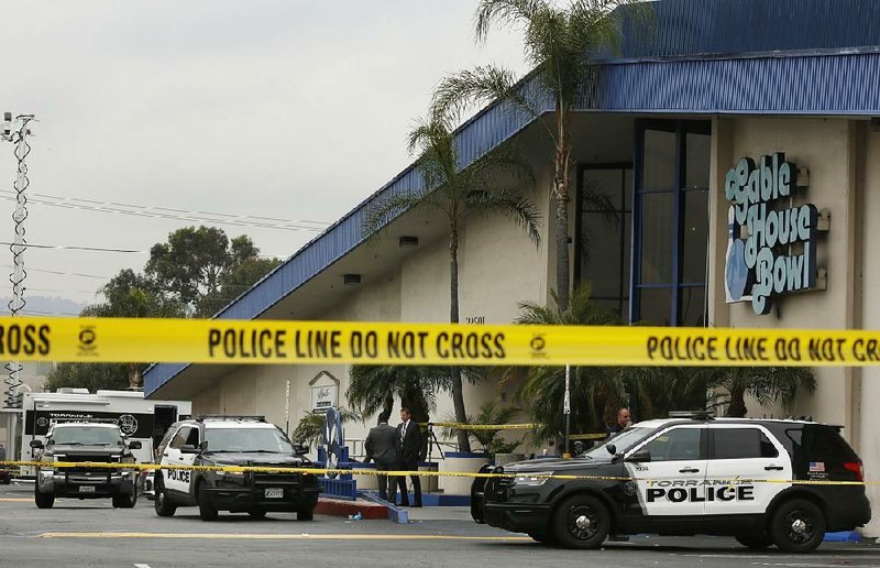 Police officers  investigate Saturday after  the  fatal shooting at Gable House Bowl in Torrance, Calif. 