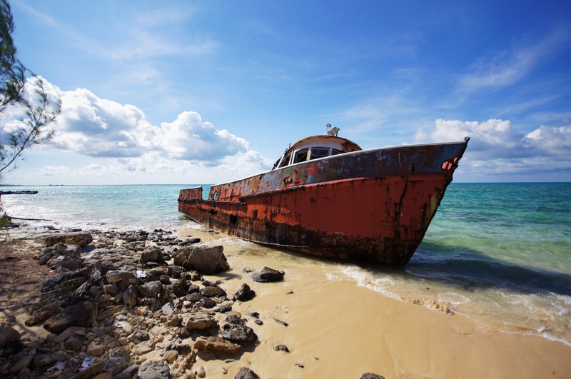 A corroding fishing boat, abandoned after its captain passed away, lists on a beach in Exuma Sound on Cat Island, Bahamas. MUST CREDIT: Photo for The Washington Post by John Briley