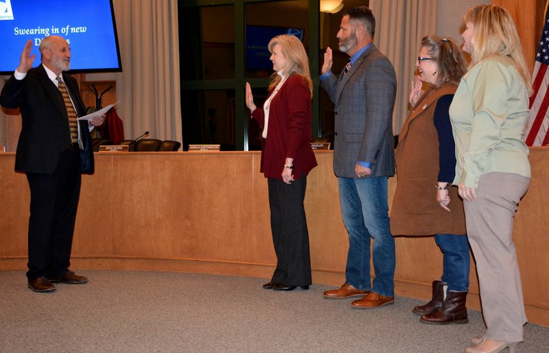 Hunter McFerrin/Siloam Sunday The city board met for the first time in 2019 on Wednesday night. The meeting began with the swearing in of three newly-elected members, as well as Brad Burns, Ward 2 Director, whose reelection was uncontested. Pictured (from left) is Ward 1 Director Mindy Hunt; Burns; Ward 3 Director Marla Sappington; Ward 4 Director Lesa Rissler (formerly Brosch).