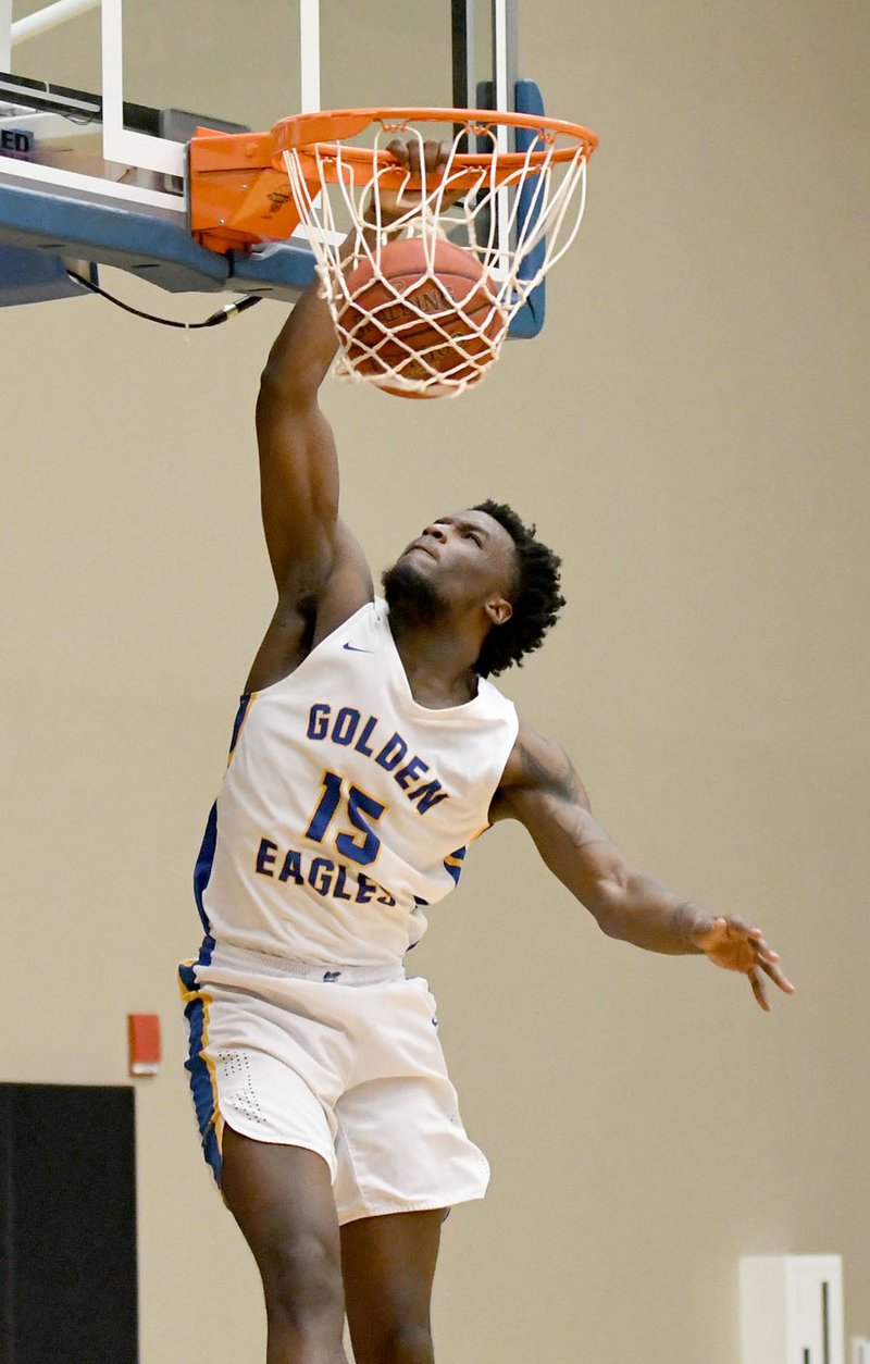 Bud Sullins/Special to Siloam Sunday John Brown sophomore Densier Carnes dunks the ball during the second half Thursday against Central Christian (Kan.) at Bill George Arena. JBU defeated Central Christian 73-37.