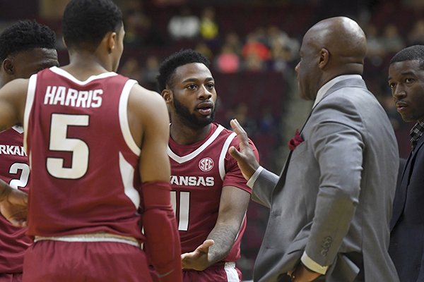Arkansas guard Keyshawn Embery-Simpson (11) speaks with head coach Mike Anderson as officials review a play in the first half of an NCAA college basketball game against Texas A&M, Saturday, Jan. 5, 2019, in College Station, Texas. (Laura McKenzie/College Station Eagle via AP)

