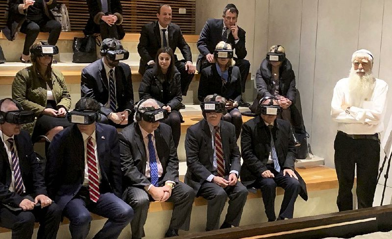 U.S. national security adviser John Bolton (front, third from left), flanked by U.S. Ambassador David Friedman and Israeli envoy Ron Dermer, takes a virtual-reality tour Sunday during a visit to the Western Wall in Jerusalem. The war in Syria was a key topic on the agenda as Bolton met with Israeli officials.