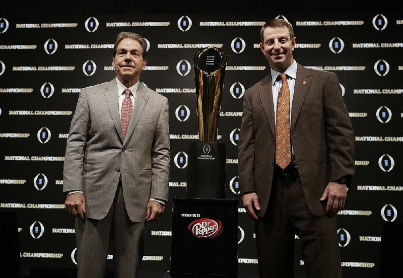 Alabama Coach Nick Saban (left) and Clemson Coach Dabo Swinney pose with the College Football Playoff national championship trophy at a news conference Sunday in Santa Clara, Calif.