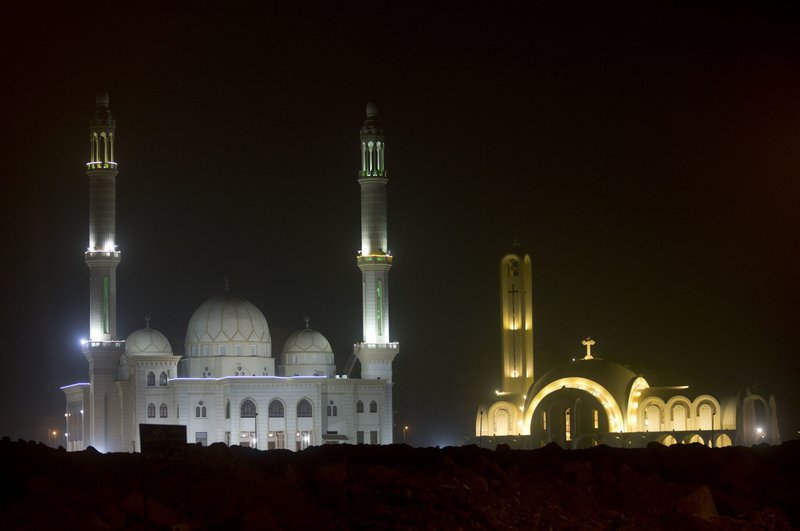 The &quot;Great St. Antony Church&quot;, right, and the Great mosque, left, are illuminated in Cairo, Egypt, Sunday, Jan. 6, 2019. The Coptic Christian population are considered to be the largest Christian community in the Middle East and observe Christmas on January 7 according to the old, Julian calendar.(AP Photo/Amr Nabil)