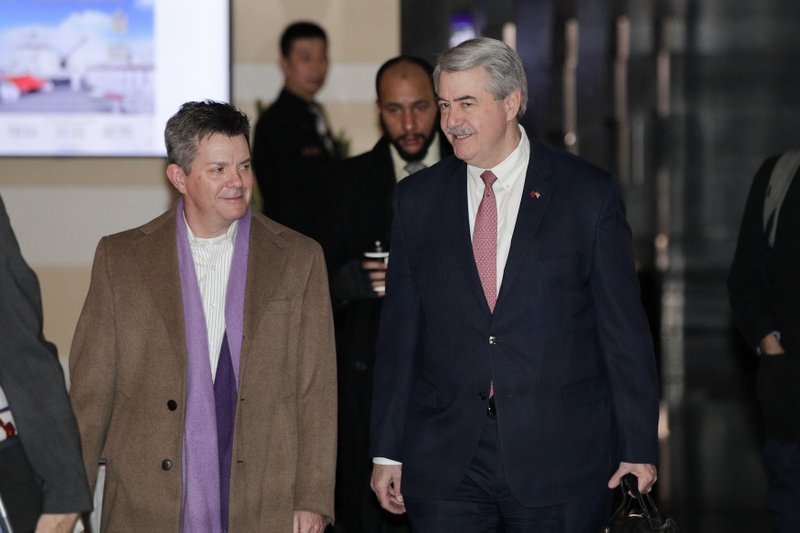 U.S. Undersecretary for Trade and Foreign Agricultural Affairs Ted McKinney, right, chats with a delegate as they leave the Westin Hotel in Beijing, Monday, Jan. 7, 2019. The U.S. delegation led by deputy U.S. trade representative, Jeffrey D. Gerrish arrived in the Chinese capital for a trade talks with China. China sounded a positive note ahead of trade talks this week with Washington, but the two sides face potentially lengthy wrangling over technology and the future of their economic relationship. (AP Photo/Andy Wong)

