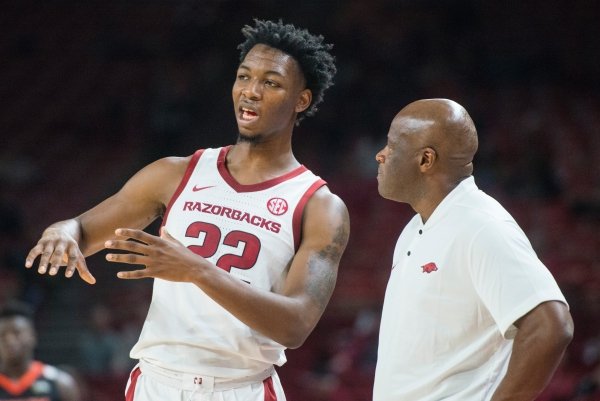 Gabe Osabuohien of Arkansas talks to head coach Mike Anderson in the second half vs Tusculum Friday, Oct. 26, 2018, during an exhibition game in Bud Walton Arena in Fayetteville.