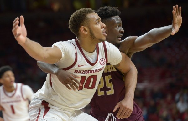 Arkansas forward Daniel Gafford (center) posts up for the ball as he is guarded Texas State forward Alonzo Sule Saturday, Dec. 22, 2018, during the second half in Bud Walton Arena. Visit nwadg.com/photos to see more photographs from the game.