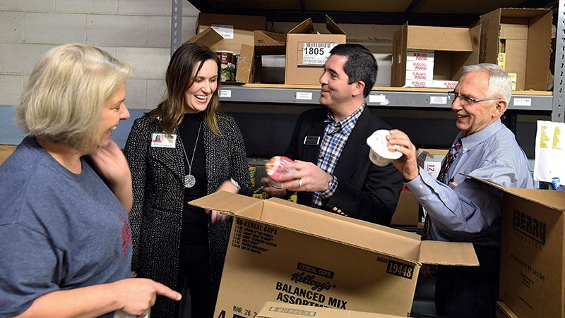 The Sentinel-Record/Grace Brown DOLLARS AT WORK: From left, Community Awareness Coordinator Becky Chote gives Arkansas Blue & You Foundation’s Rebecca Pittillo, Jeremy Brown, and Wallace Thomas a tour of Project HOPE Food Bank on Monday. The foundation awarded the organization a $25,000 grant for its Senior Emergency Box Program.