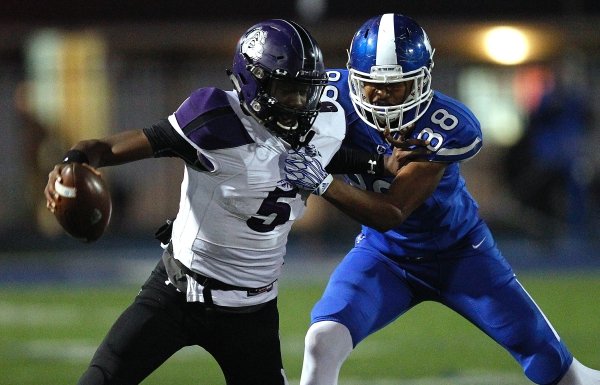 Bryant defensive end Catrell Wallace (88) tackles Fayetteville quarterback Darius Bowers (5) during the second quarter of Bryant's 28-25 win on Friday, Nov. 16, 2018, at Bryant High School.