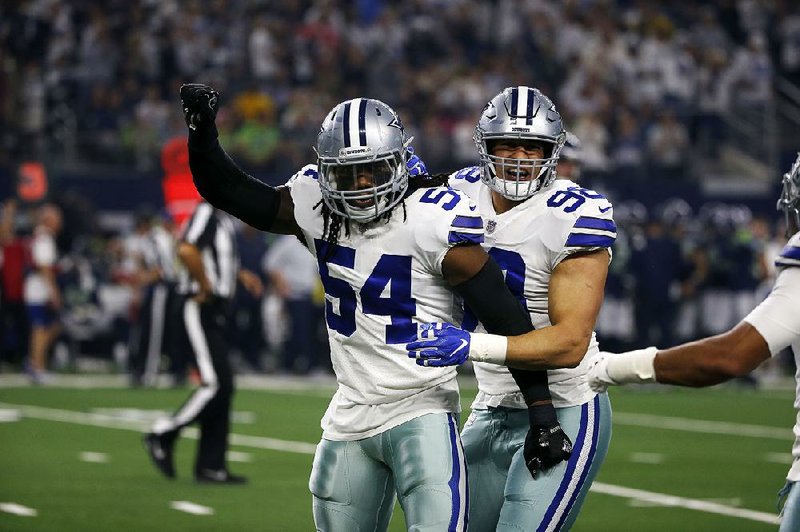 Jaylon Smith (54) and Tyrone Crawford celebrate Dallas’ victory Saturday over Seattle. The Cowboys now travel to Los Angeles to face the Rams.