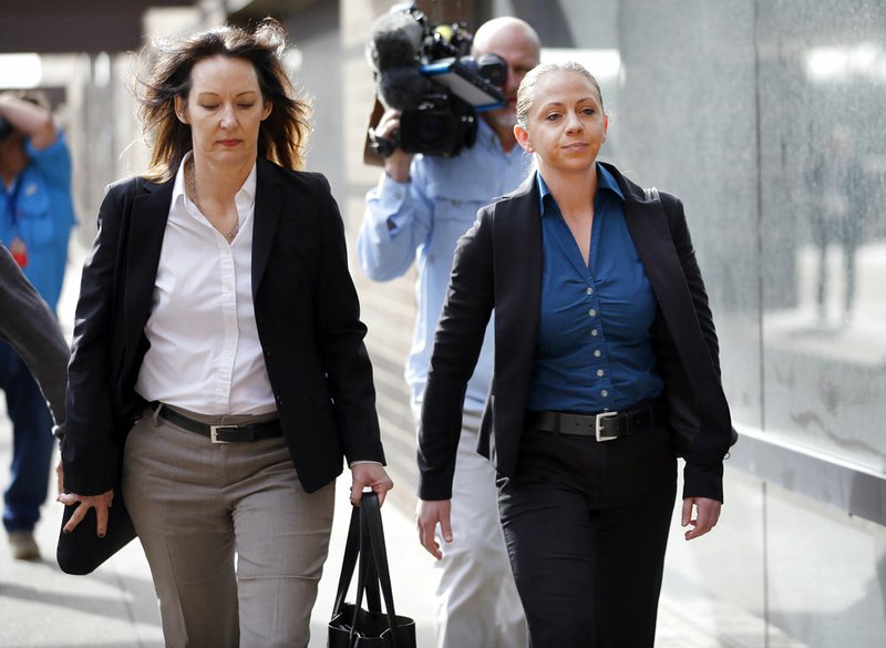 Former Dallas police officer Amber Guyger, right, leaves the Frank Crowley Courts Building in downtown Dallas, after making her first court appearance, Tuesday, Jan. 8, 2019. Guyger is charged in the Sept. 6, 2018 fatal shooting of Botham Jean, her unarmed black neighbor, whose apartment she says she mistook as her own. (Tom Fox/The Dallas Morning News via AP)
