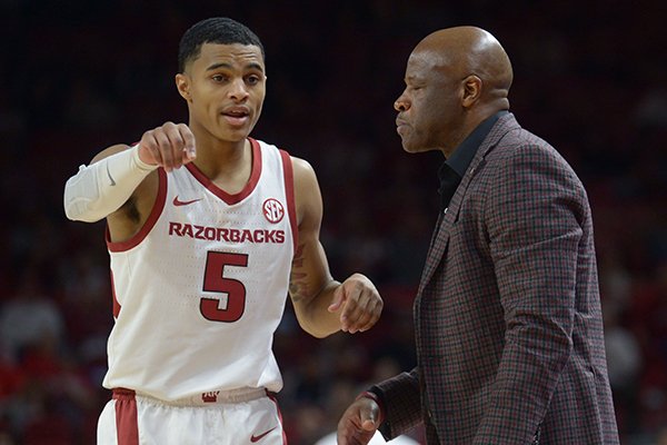 Arkansas guard Jalen Harris speaks with coach Mike Anderson against Texas State Saturday, Dec. 22, 2018, during the second half in Bud Walton Arena.