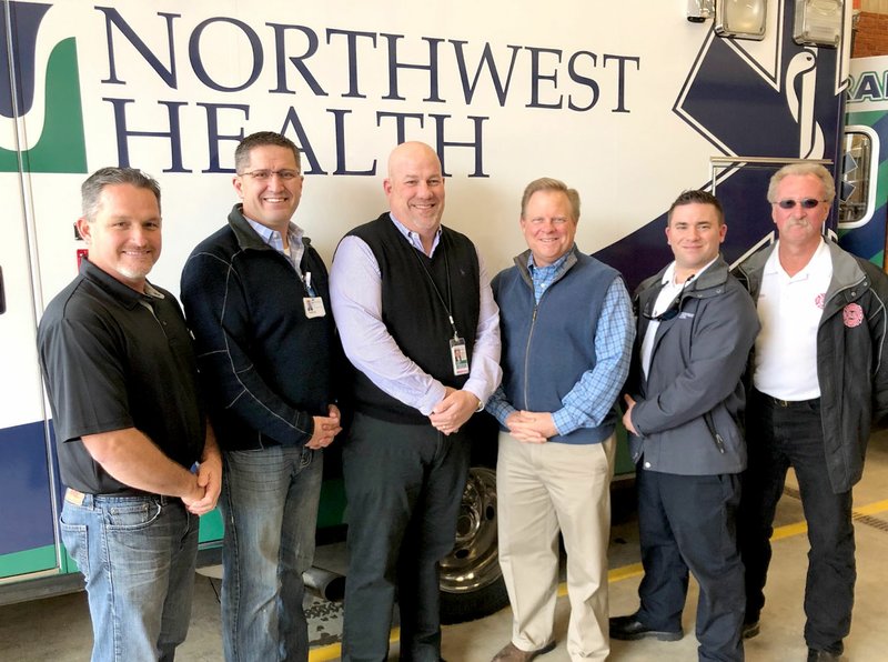 Photo submitted Gentry and Benton County officials joined with Northwest Health leaders to participate in a push-in ceremony at the Gentry Fire Department on Dec. 31. The ceremony marked the launch of EMS coverage in western Benton County, which began on Jan. 1. Pictured, from left, are Kevin Johnston, Gentry Mayor; Charles Hall, Assistant CEO of Northwest Medical Center-Springdale; Robert McGowan, administrator of Benton County's Division of Public Safety; Barry Moehring, Benton County Judge; Mike Pittman, Director of EMS for Northwest Health; and Vester Cripps, Gentry Fire Chief.