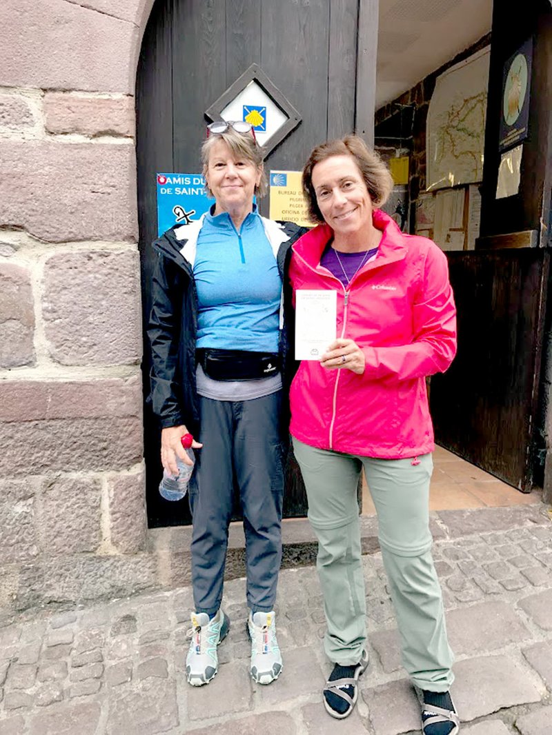 Photo submitted Every pilgrim on the Camino de Santiago must stop for a passport before beginning. Beth Haller and Carie O'Banion pose outside the Pilgrim office in St. Jean Pied de Port France.