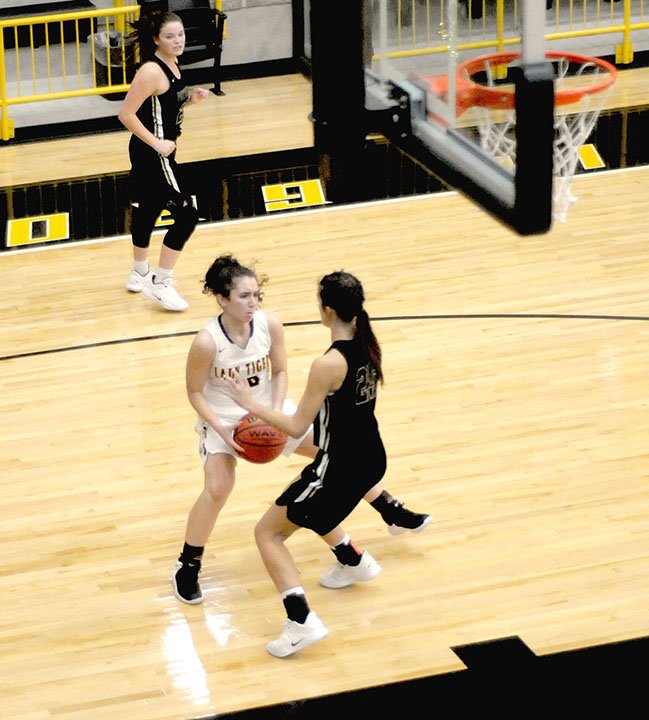 MARK HUMPHREY ENTERPRISE-LEADER Prairie Grove senior Lexie Madewell, shown making a move against Pottsville during a November overtime game, exposes the ball on this play risking a held-ball that leads to alternating possession. Lady Tiger head coach Kevin Froud is urging the 2018-2019 Lady Tiger girls basketball team to play smart.