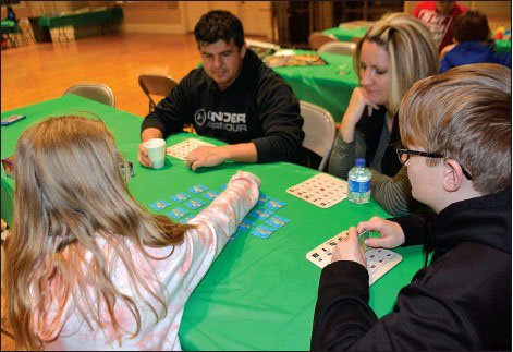 File photo Attendees of last year's family game night each took their turns in a Dr. Suess Matching game. Pictured, (from left) is father Henry Janes, mother Becky Janes, Truman Janes, 13, and Hailey Janes, 9.