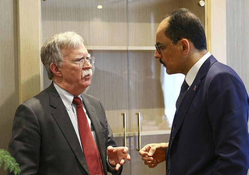 U.S. National Security Adviser John Bolton, left, and his Turkish counterpart and senior adviser to President Recep Tayyip Erdogan, Ibrahim Kalin, right, talk at the Presidential Palace in Ankara, Turkey, Tuesday, Jan. 8, 2019. Bolton has said he is trying to negotiate the safety of Kurdish allies in northeastern Syria in the fight against the Islamic State group(Presidential Press Service via AP, Pool)