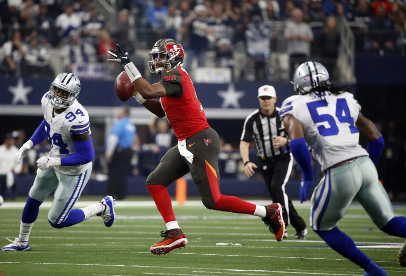  In this Dec. 23, 2018, file photo, Dallas Cowboys' Randy Gregory (94) and Jaylon Smith (54) pursue as Tampa Bay Buccaneers quarterback Jameis Winston (3) prepares to throw a pass during an NFL football game in Arlington, Texas.  (AP Photo/Michael Ainsworth, File)
