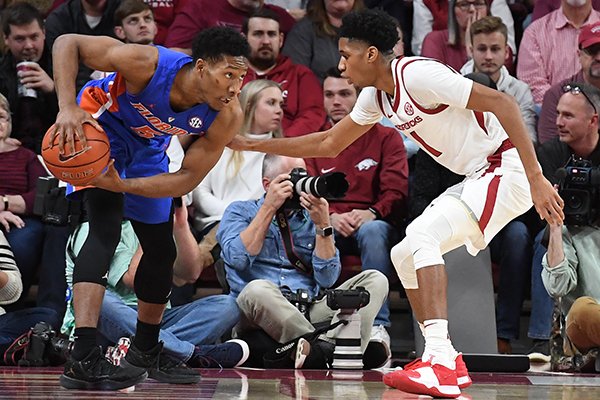 Florida senior KeVaughn Allen (left) is guarded by Arkansas freshman Isaiah Joe during a game Wednesday, Jan. 9, 2019, in Fayetteville. 
