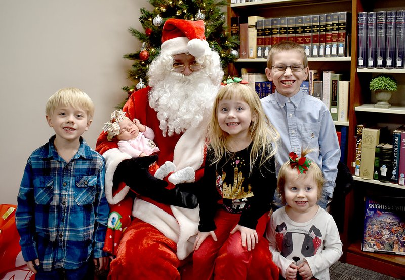 Courtesy photo The Cartwright family enjoys meeting Santa at a recent "Book and A Bear" event at the McDonald County Library in Pineville. Noah, Barrett, Adalyn, Abigail and baby Chasidi Cartwright grinned for the camera at the December event that catapulted the library into uncharted waters of success. The Pineville and Southwest City library events drew 450 visitors, including 300 children. Youngsters had the opportunity to enjoy games, snacks and stories, have their photo taken with Santa and receive a free book and a bear. Three hundred books and bears were distributed.