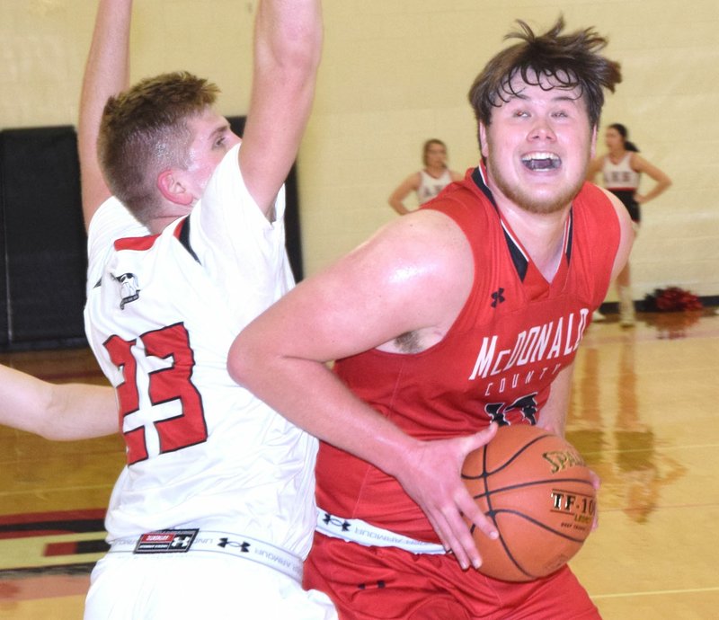 RICK PECK/SPECIAL TO MCDONALD COUNTY PRESS McDonald County's 6-5 forward Cooper Reece powers past Aurora's Kaden Clark for two of his team-high 15 points in the Mustangs' 48-39 win on Jan. 4 at Aurora High School.