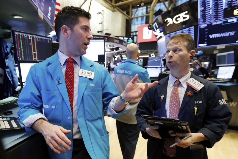 Specialist Thomas McArdle, left, and trader Robert Charmak work on the floor of the New York Stock Exchange, Wednesday, Jan. 9, 2019. Stocks are opening higher on Wall Street, putting the market on track for a fourth gain in a row. (AP Photo/Richard Drew)